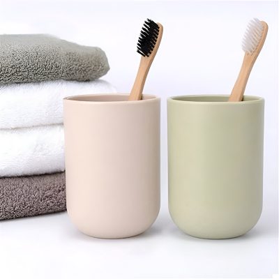Gentlemen's dental hygiene routine with eco-friendly toothbrushes in stylish ceramic cups, accompanied by soft, plush towels for a clean, relaxing experience. Perfect for modern oral care and bathroom decor.
