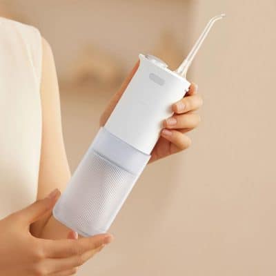 Portable dental water flosser for oral care, dental hygiene, and teeth cleaning, featuring a sleek design, rechargeable battery, and durable water reservoir for effective plaque removal.