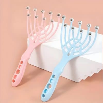 Colorful facial massage tools with rounded metal tips in pink and blue on a white platform against a peach background. Perfect for skincare, facial therapy, and beauty routines at Monalisa Store.