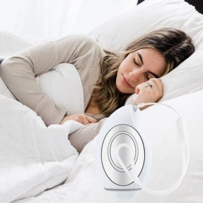 Soothing woman sleeping peacefully with medical device for sleep therapy on her pillow, promoting restful sleep and health improvement, featured at Monalisa Medical Store.