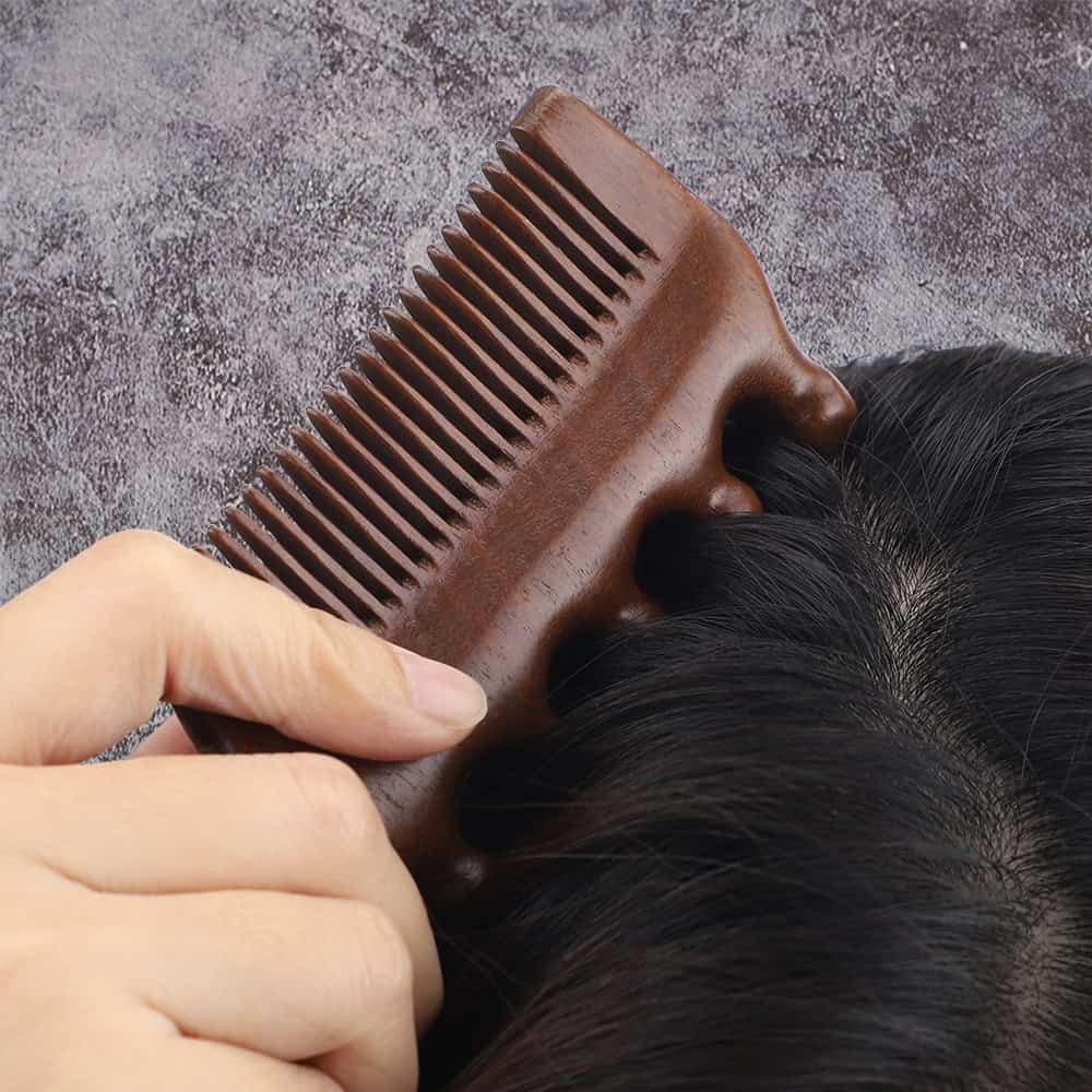 Healthy black scalp being detangled with a wooden comb, demonstrating professional hair care and scalp health services at Monalisa Store.