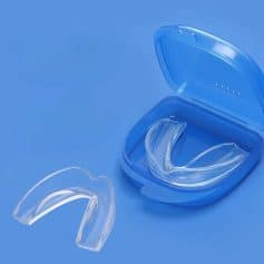 Clear dental night guard in a blue case, suitable for teeth grinding and clenching prevention, offering comfortable fit and protection, designed for optimal oral health.