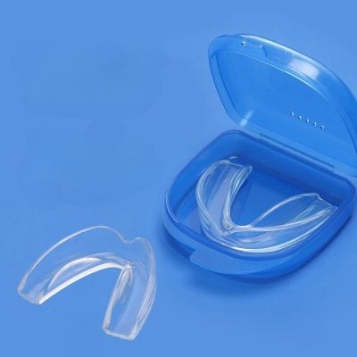 Clear dental night guard in a blue case, suitable for teeth grinding and clenching prevention, offering comfortable fit and protection, designed for optimal oral health.