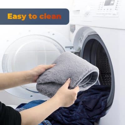 Cleaning laundry with plush blanket in front-loading washing machine.