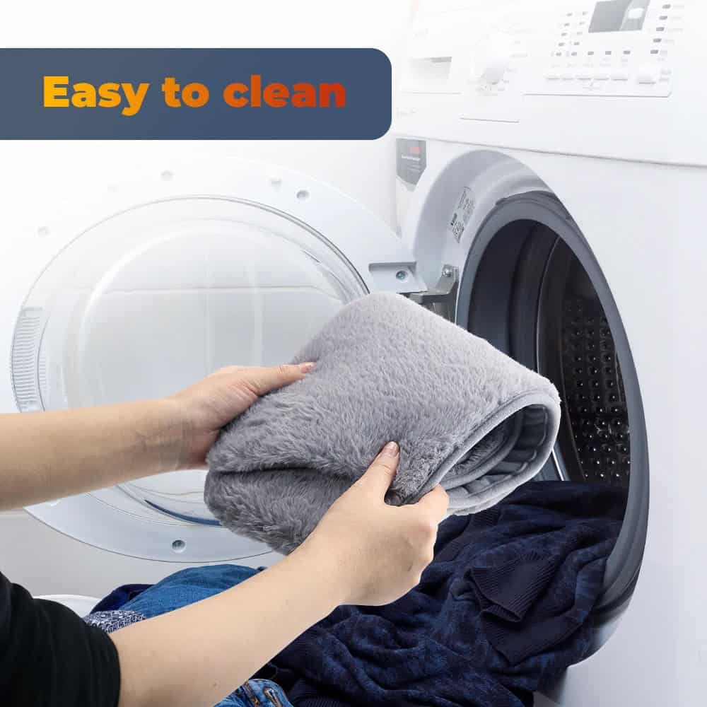 Cleaning laundry with plush blanket in front-loading washing machine.