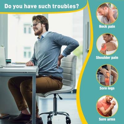 A man experiencing back pain at his desk caused by neck, shoulder, sore legs, or sore arms.