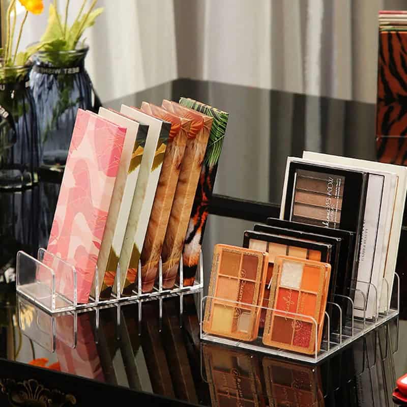 Pink and green patterned makeup palettes on display at Monalisa Store for eye and face cosmetics.