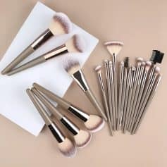 Luxurious makeup brushes with soft bristles on a beige background, perfect for professional or everyday makeup application, emphasizing quality and beauty tools.