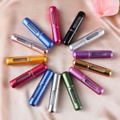 Vape pen set in multiple vibrant colors arranged in a circle on soft pink fabric, showcasing sleek and modern design, ideal for health and wellness enthusiasts interested in vaping products.