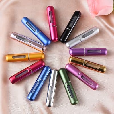 Vape pen set in multiple vibrant colors arranged in a circle on soft pink fabric, showcasing sleek and modern design, ideal for health and wellness enthusiasts interested in vaping products.