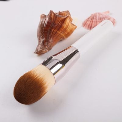 Natural makeup brush with seashells for beauty and skincare, ideal for foundation and powder application, emphasizing quality cosmetic tools for flawless looks at Monalisa Store.
