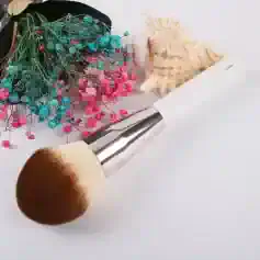 Blue and pink dried flowers with makeup brush and seashell piece for beauty and skincare product display, Monalisa Store.