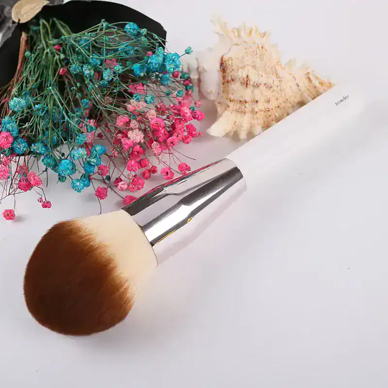 Blue and pink dried flowers with makeup brush and seashell piece for beauty and skincare product display, Monalisa Store.