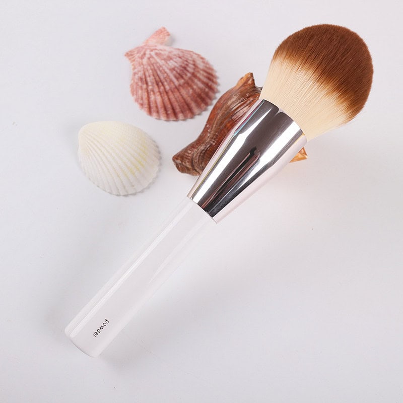 Silicone makeup brush with seashells background, beauty tools for cosmetic application, Monalisa Store.
