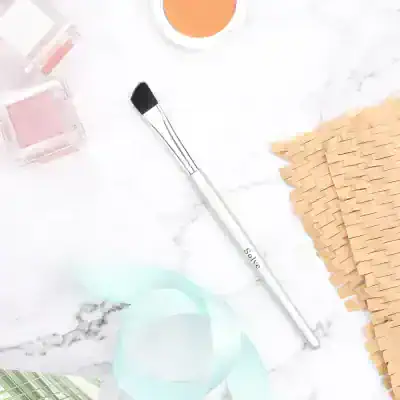 Bright makeup brush and beauty products on marble surface for skincare and cosmetics supplies at Monalisa Store.