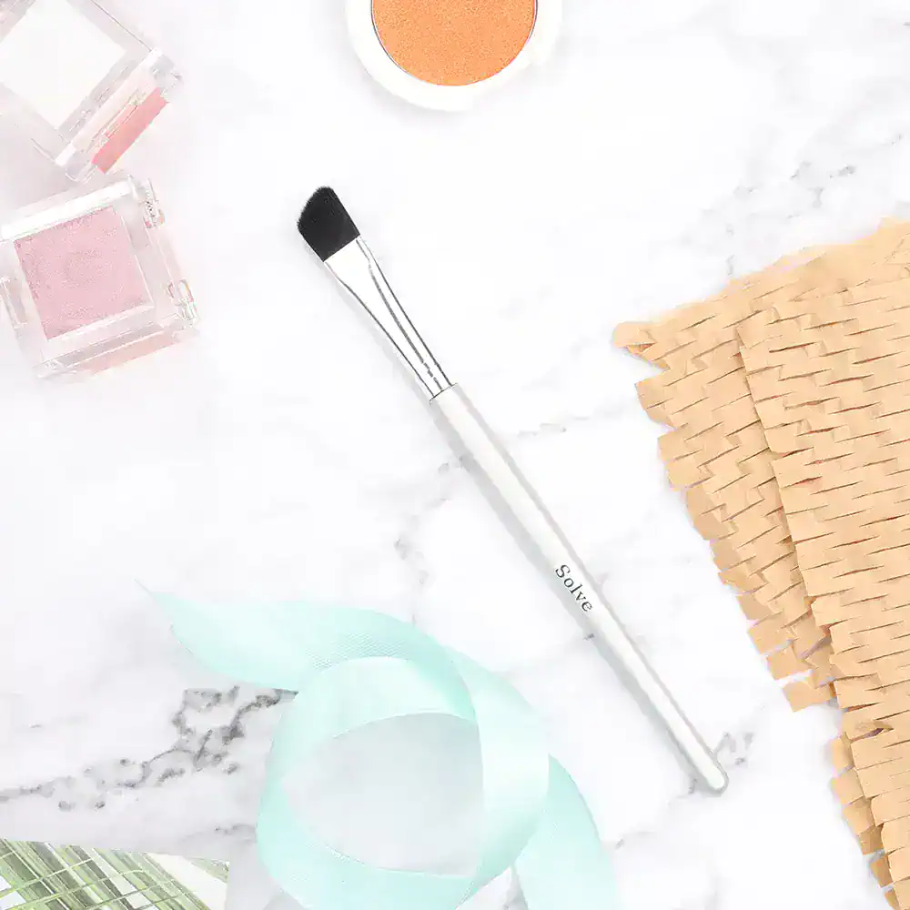 Bright makeup brush and beauty products on marble surface for skincare and cosmetics supplies at Monalisa Store.