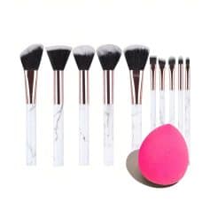 Brush set for makeup application with a marble design handle and a pink beauty blender sponge, ideal for professional and everyday cosmetic use.