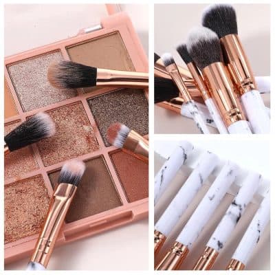 Eyeshadow palette with neutral and shimmering shades for makeup look enhancement, set alongside various makeup brushes with rose gold and marble handles for professional cosmetic application.