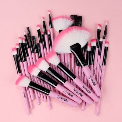 Pink and black makeup brushes set for cosmetics, blending, blush, and eyeshadow applications, ideal for professional and at-home beauty routines.