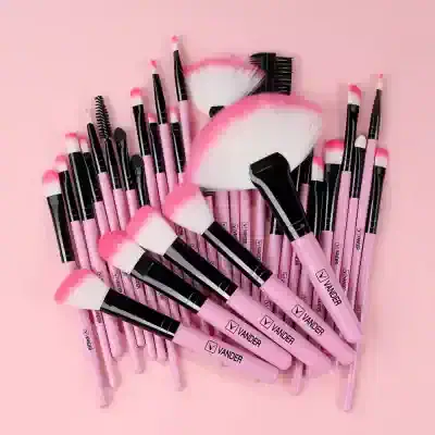 Pink makeup brushes set with black accents, ideal for eye and face makeup, displayed on a pink background. Perfect tools from Monalisa MedSpa for professional and beauty routine use.