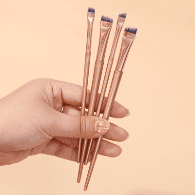 Fluffy artist makeup brushes set for cosmetic application, rose gold color, professional beauty tools, delicate and stylish makeup brushes, perfect for eye and face makeup application.