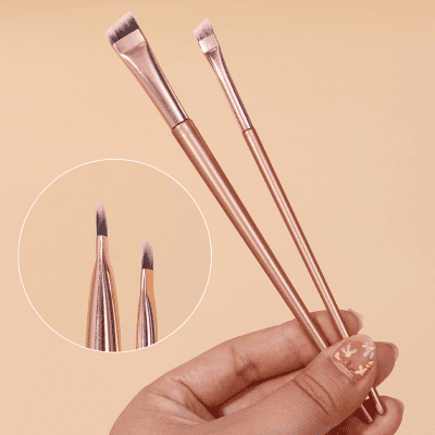 Soft pink makeup brushes set with synthetic bristles for eye and face makeup application, includes angled and flat brushes, perfect for professional or personal use.