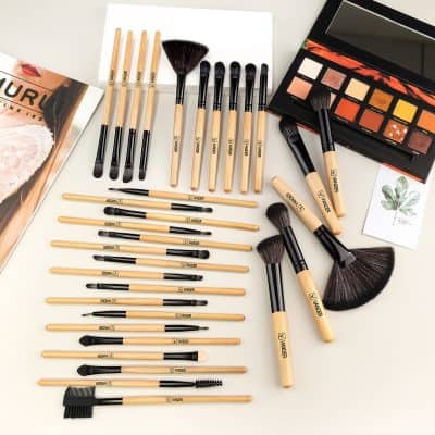 Cosmetic makeup brushes set on white surface, eye shadow palette, and beauty tools for professional makeup application, Monalisa Store opt, high-quality beauty accessories for makeup artists and enthusiasts.