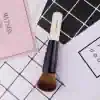 Full coverage face makeup brush for flawless makeup application, black and white handle, synthetic bristles, ideal for foundation, blush, and contour, essential in beauty and makeup tools.