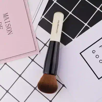 Full coverage face makeup brush for flawless makeup application, black and white handle, synthetic bristles, ideal for foundation, blush, and contour, essential in beauty and makeup tools.