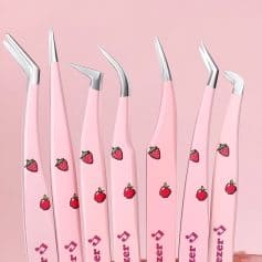 Pink strawberry-themed dental tools with ergonomic handles on a pink background, ideal for professional dental care and orthodontic procedures.