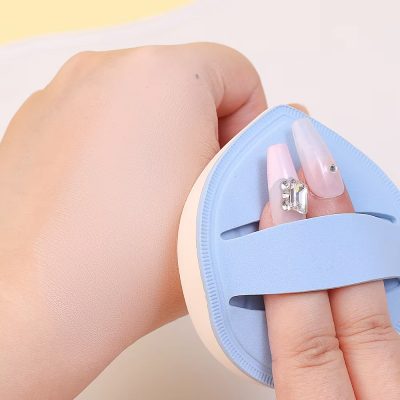 Extending long acrylic nails with rhinestones, hand holding a nail drill with a blue silicone thumb guard for nail art and manicures, close-up of professional nail extension tools and accessories for beauty salons, Monalisa Store.
