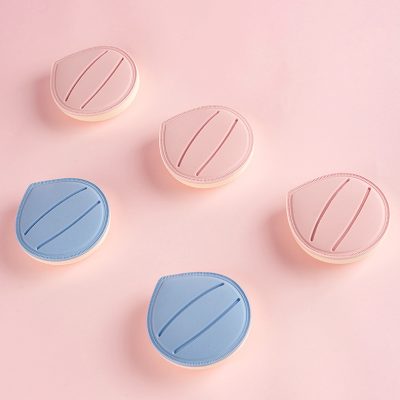 Pink and blue contact lens cases on a pink background, secure storage containers for contact lenses, hygienic contact lens accessories, Monalisa Store.