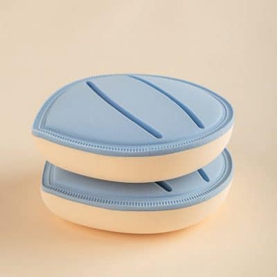 Silicone contact lens case in pastel blue and white, compact and portable for safe eye care storage. Suitable for travel and daily use, ensuring hygiene and organized storage for contact lens users.