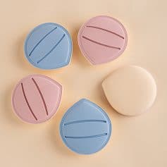 Blue and pink silicone contact lens cases for eye care and storage.