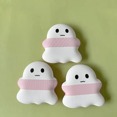 Fluffy ghost plush toys with pink band, cute kawaii character, soft and huggable, perfect for friends or kids, adorable decor for children's rooms or Halloween.