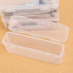 Plastic storage case for makeup brushes with clear lid.