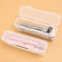 Toothbrush and dental tools in storage boxes for dental care and hygiene.