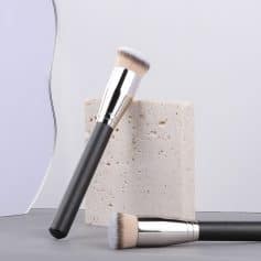 Luxurious makeup brushes with black handles and soft bristles displayed on a minimalist setting for skincare and beauty products at Monalisa Store.