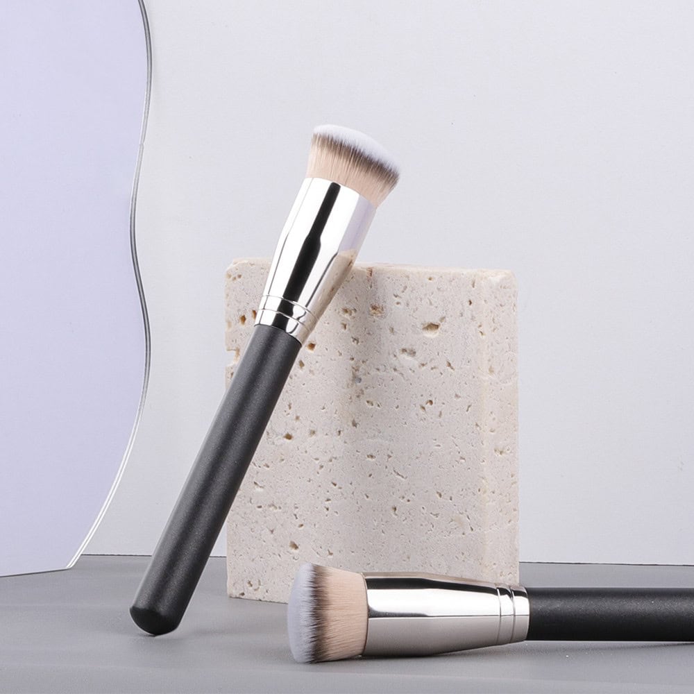 Luxurious makeup brushes with black handles and soft bristles displayed on a minimalist setting for skincare and beauty products at Monalisa Store.