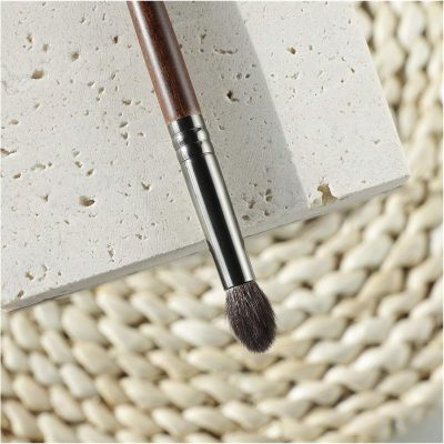 Sculpting brush resting on textured stone surface, ideal for professional cosmetic and beauty treatments, high-quality tools for skincare and makeup application at Monalisa Store.