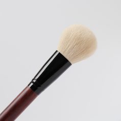 Soft makeup brush with natural bristles and wooden handle, used for face makeup applications at Monalisa Medical Store. Perfect for blending powders and achieving flawless makeup looks.