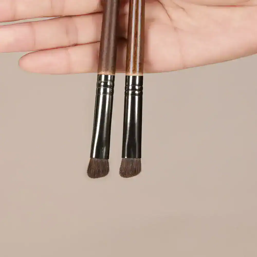High-quality makeup brushes held by hand, ideal for professional cosmetic application, beauty products, and skincare routines. Perfect for achieving flawless makeup looks.