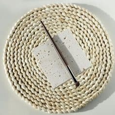 Natural stone makeup palette with brush on woven placemat, beauty and skincare product for cosmetic application.