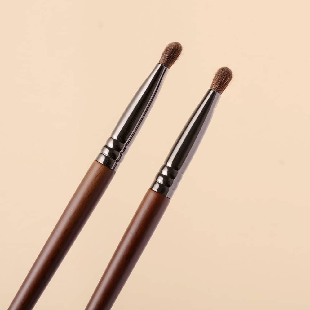 Soft makeup brushes with wooden handles and nickel ferrule tips, ideal for professional and daily cosmetics application, showcased against a neutral beige background.