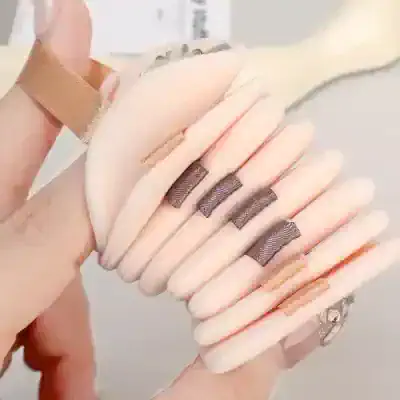 Silicone finger protectors with metallic strips, used for skincare or beauty treatments, displayed on a person's hand at Monalisa Store.