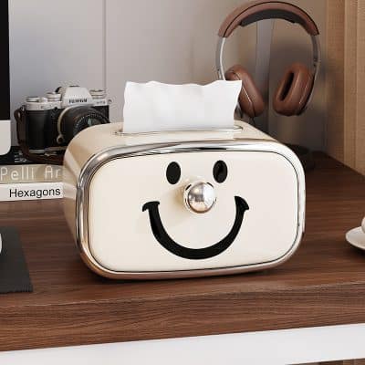 Smile face tissue box with retro design on a wooden desk.
