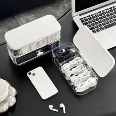 Charging station with multiple cables, power bank, and a smartphone on a desk, ideal for modern tech accessories and electronic devices.