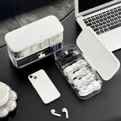 Charging station with multiple cables, power bank, and a smartphone on a desk, ideal for modern tech accessories and electronic devices.