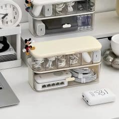 Organized cable storage container for electronics and accessories, perfect for home office or workspace organization.