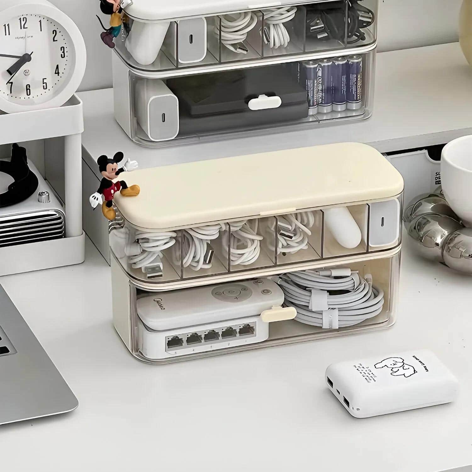 Organized cable storage container for electronics and accessories, perfect for home office or workspace organization.